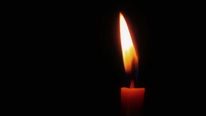 Warm candle flame near the end of the film